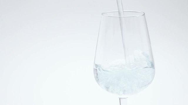 Water pour into wineglass