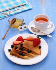 Stack of pancakes, fresh strawberry blueberry, honey