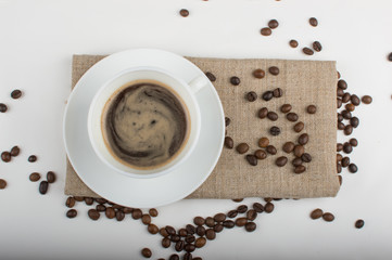 Coffee cup and beans on a white background.