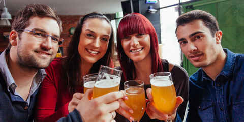 Group Of Friends In Tavern Taking Selfie