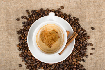 Coffee cup and beans on a background.