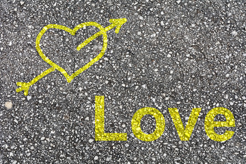 A heart and the word "love" painted on the pavement © paulafontana