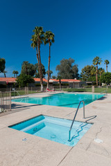Two swimming pools with palm trees and chair