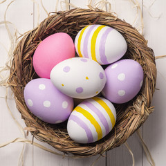 Colorful Easter eggs in the nest. Top view