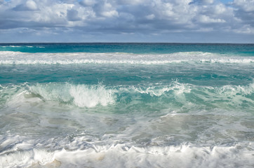 White foamy waves and gradually darkening color of sea water