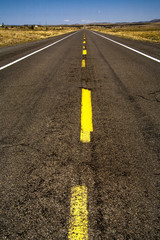 A yellow traffic stripe divides a highway in Arizona.