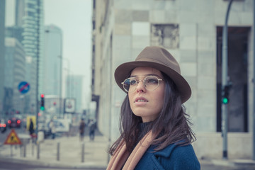 Beautiful young brunette posing in the city streets