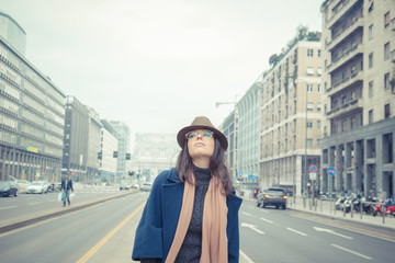 Beautiful young brunette posing in the city streets