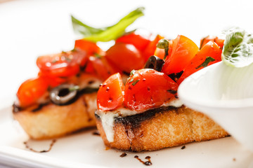 Bruschetta with tomato, mozarella and basil