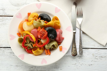 Tasty multicolor pasta with pepper, carrot and tomatoes