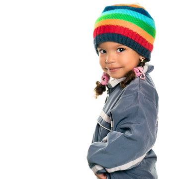 Funny mixed race small girl wearing winter clothes