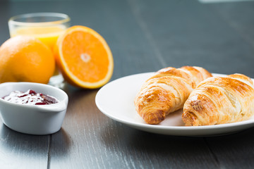 delicious breakfast with croissants in bed