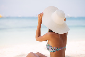 Beautiful woman sit on the sand