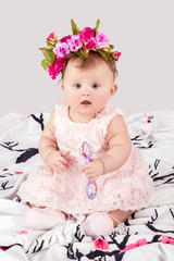 Fototapeta premium Portrait of baby with a rattle on the blanket