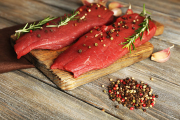 Raw beef steak with rosemary and spices