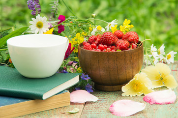 Books, flowers and white cup