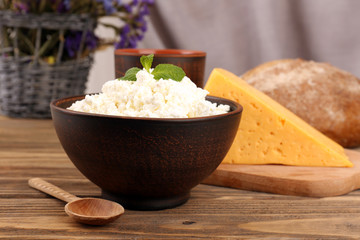 Tasty dairy products with bread and dry flowers