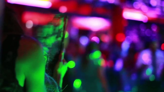 Sexy girl with fan in nightclub