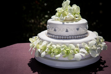 large wedding cake with white orchids and pearls
