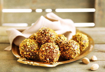 Tasty homemade pistachio candies on wooden table