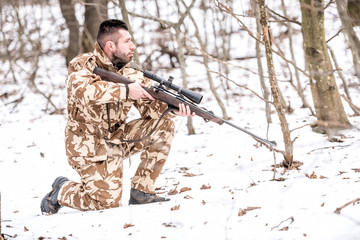 Military man in camouflage uniform preparing for battle