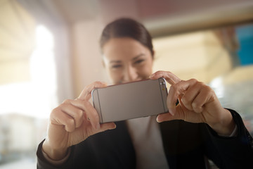 Woman taking a picture with her mobile