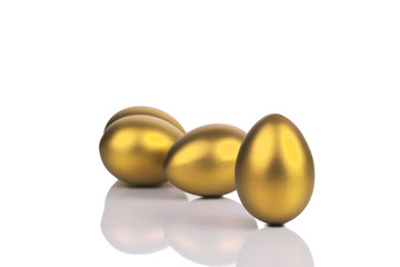 Golden eggs isolated on white background