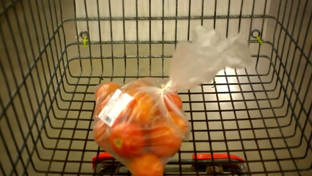 Customer shopping at supermarket with trolley. Video shift