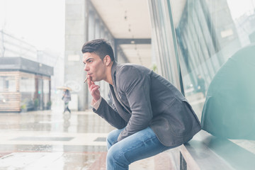 Young handsome man smoking a cigarette