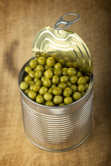 Opened tin with green peas