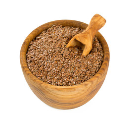 flax seed in a wooden bowl isolated on white