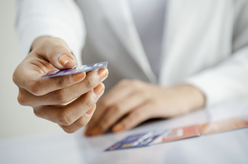 Closeup of woman hand giving credit card