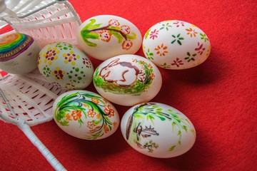 Easter eggs in basket on color background