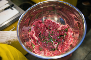 Raw Flank Steaks with spice and thyme in bowl