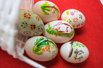 Fototapeta na wymiar Easter eggs in basket on color background