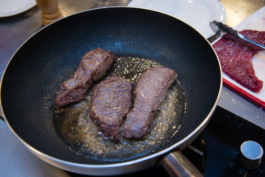 Frying stewed steaks on hot fraying pan
