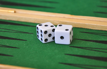 two dice on a green gaming table.