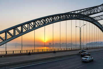 Fototapeta na wymiar road through the bridge with blue sky background of a city