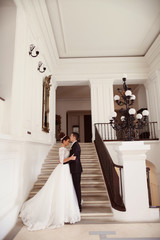 Fototapeta na wymiar Bride and groom in a white palace
