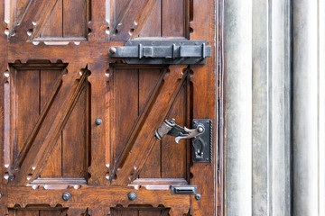 Old wooden door with wrought iron handle