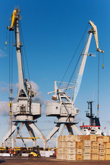 Wooden blocks on the loading at the port with cranes