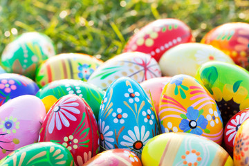 Hand-painted Easter eggs on grass. Spring patterns art, unique.