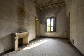 old abandoned room with window and fireplace