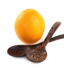 Orange fruit and wooden spoon isolated on white