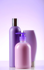 Cosmetic bottles on light background