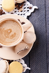 Gentle colorful macaroons and  coffee in mug