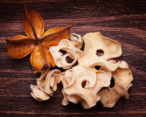 Old dried up flower and an unrecognizable plant on a wooden vint
