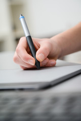 close up hands working with graphic tablet and keyboard