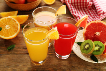 Fresh juices with fruits on wooden table
