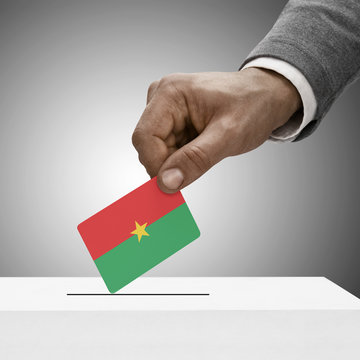 Black male holding flag. Voting concept - Burkina Faso